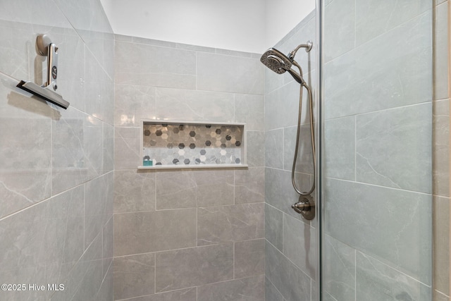 bathroom with tiled shower