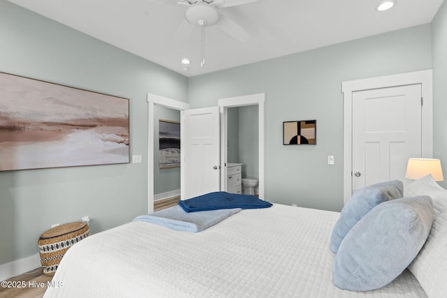 bedroom with recessed lighting, wood finished floors, and baseboards