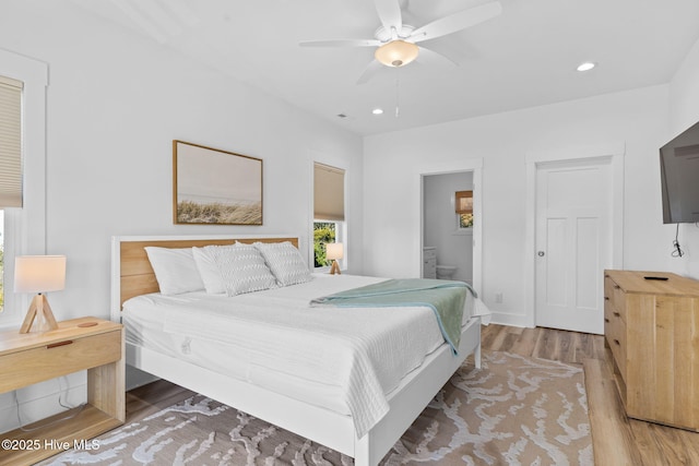 bedroom with a ceiling fan, visible vents, ensuite bath, light wood-style flooring, and recessed lighting