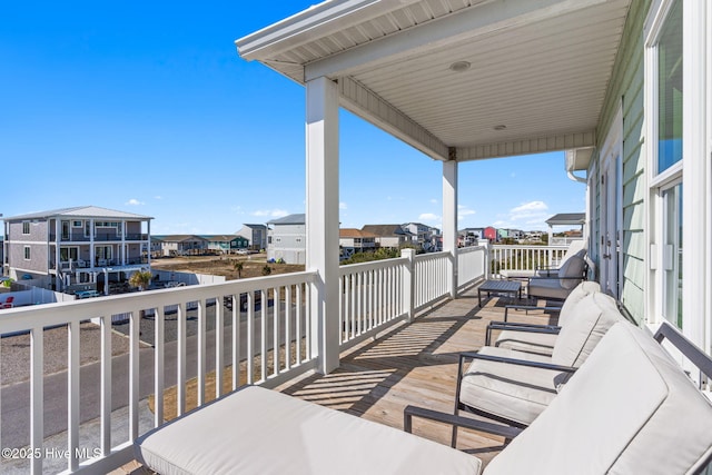 balcony with an outdoor living space and a residential view