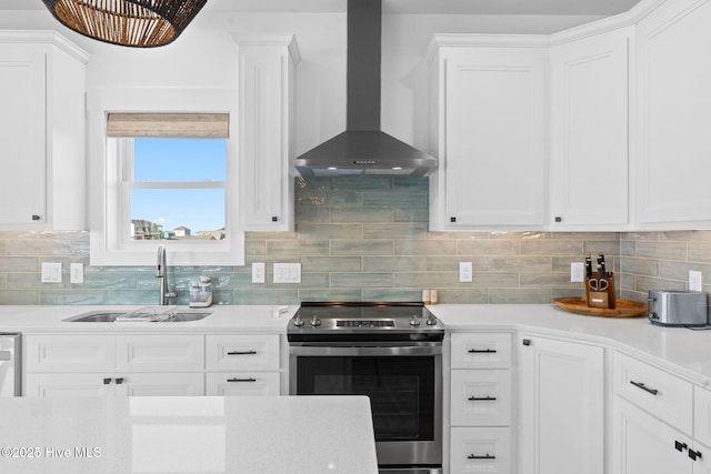 kitchen with a sink, decorative backsplash, light countertops, stainless steel range with electric stovetop, and wall chimney range hood