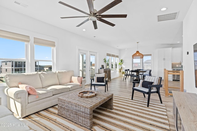 living area with light wood-style flooring, recessed lighting, a ceiling fan, and visible vents