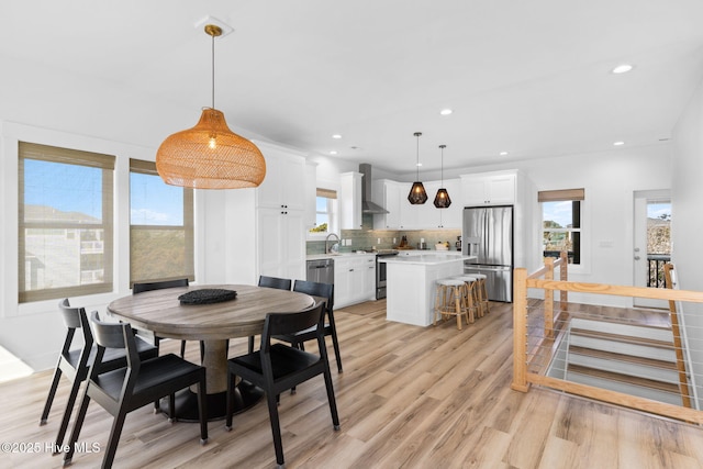 dining room featuring recessed lighting and light wood-style floors