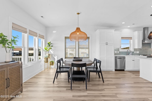 dining area featuring light wood finished floors, visible vents, and recessed lighting