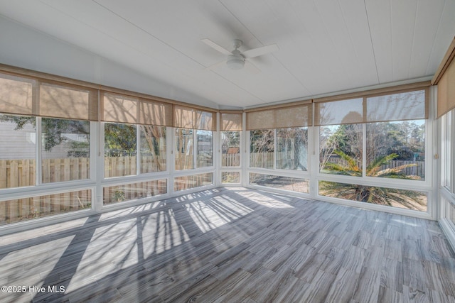 unfurnished sunroom with a wealth of natural light, ceiling fan, and lofted ceiling