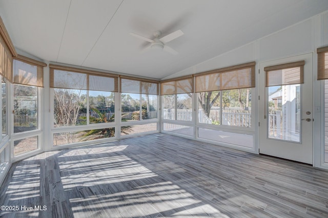 unfurnished sunroom featuring lofted ceiling and a ceiling fan