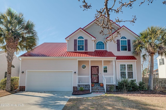 view of front of property featuring a porch, metal roof, fence, a garage, and driveway