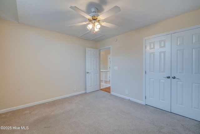 unfurnished bedroom featuring a ceiling fan, a closet, baseboards, and carpet flooring