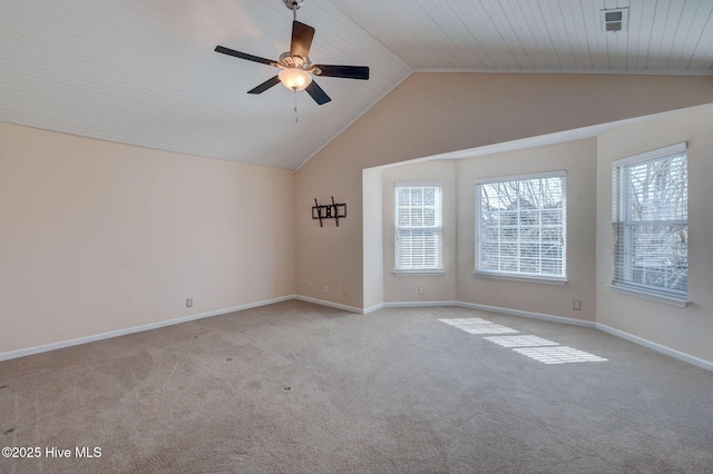 empty room featuring baseboards, vaulted ceiling, and carpet flooring