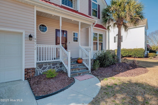 property entrance with covered porch and an attached garage