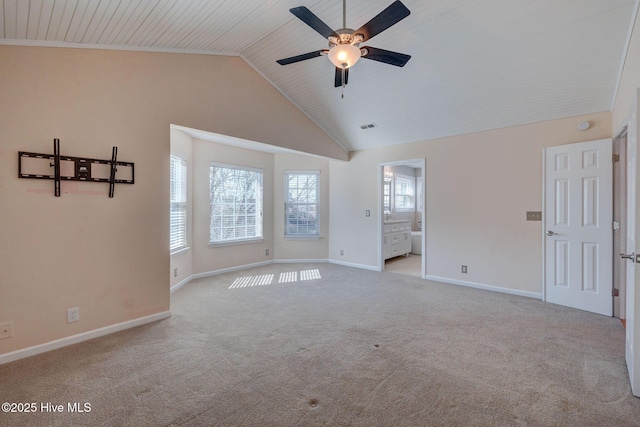 carpeted empty room featuring high vaulted ceiling, visible vents, baseboards, and ceiling fan