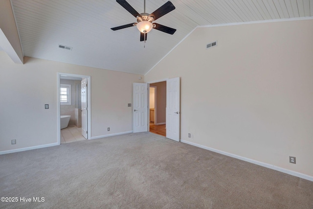 unfurnished bedroom with ensuite bath, baseboards, visible vents, and light colored carpet