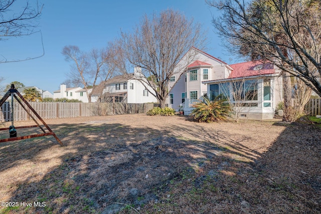 view of yard featuring a sunroom and fence