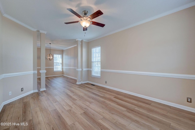 empty room with light wood-type flooring, baseboards, crown molding, and ornate columns