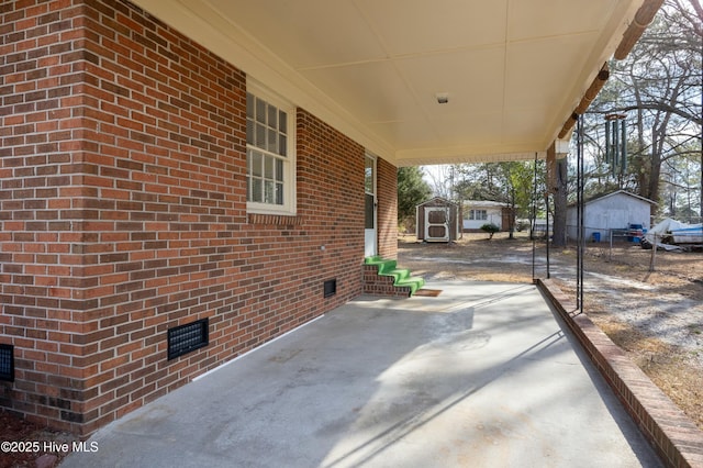 view of patio / terrace featuring an outbuilding, a storage shed, and fence