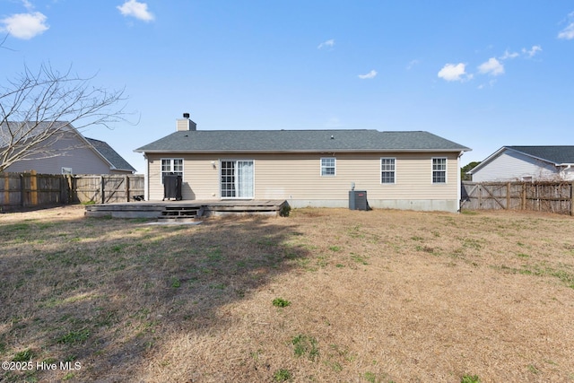 back of house with a deck, central AC, a lawn, and a fenced backyard