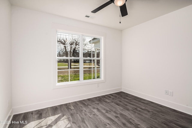 unfurnished room featuring visible vents, a ceiling fan, baseboards, and dark wood-style flooring