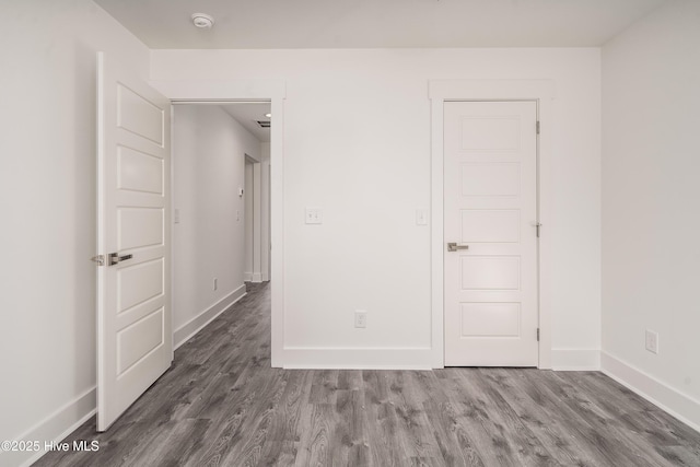 unfurnished bedroom featuring baseboards and wood finished floors