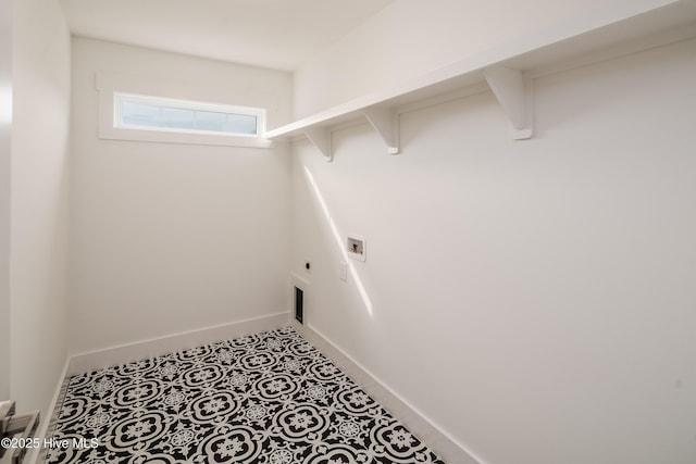 laundry room with baseboards, hookup for an electric dryer, laundry area, washer hookup, and tile patterned flooring