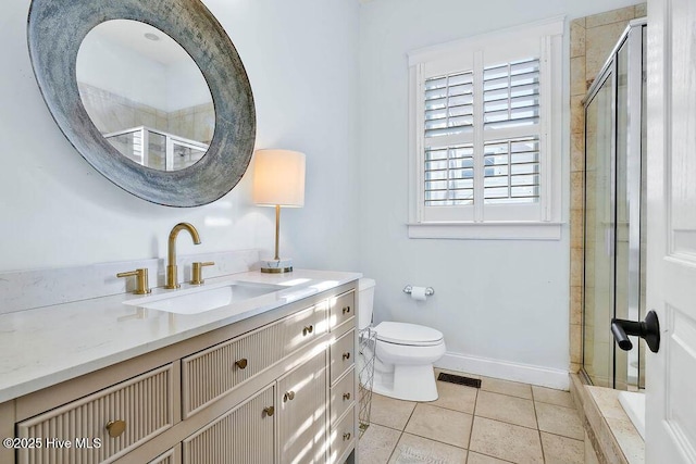 bathroom with toilet, a shower stall, vanity, and tile patterned floors