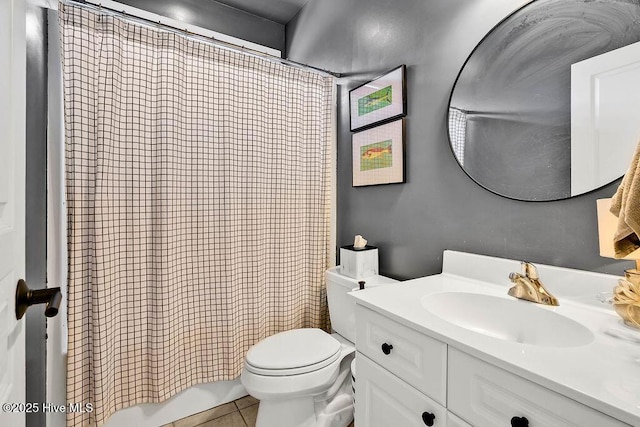 bathroom featuring tile patterned flooring, shower / tub combo with curtain, vanity, and toilet