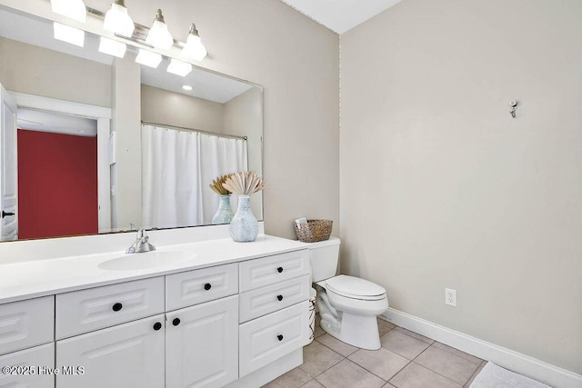 bathroom with curtained shower, toilet, vanity, baseboards, and tile patterned floors