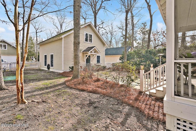 view of home's exterior with fence