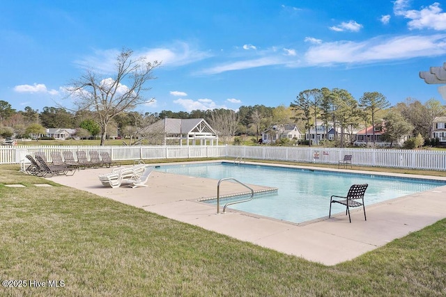 community pool featuring a yard, a patio, and fence