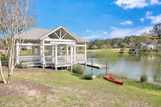 view of dock with a water view and a yard