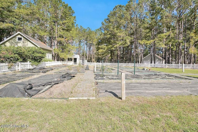 view of yard with an outbuilding and fence