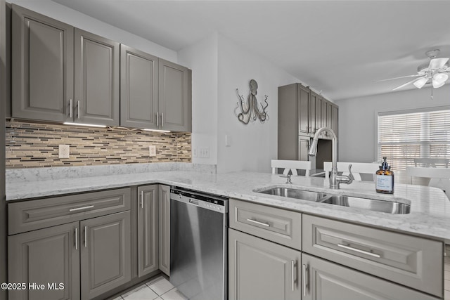 kitchen featuring a sink, gray cabinets, and dishwasher