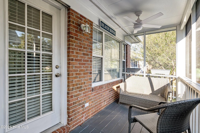 wooden deck with a porch and a ceiling fan