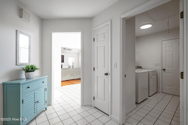 washroom featuring light tile patterned flooring, laundry area, visible vents, independent washer and dryer, and attic access