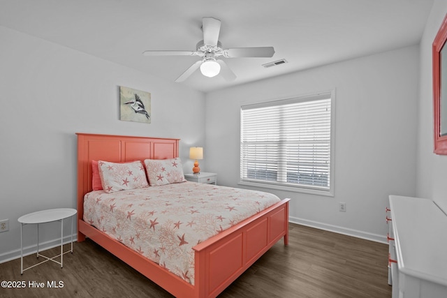 bedroom with dark wood-type flooring, a ceiling fan, visible vents, and baseboards