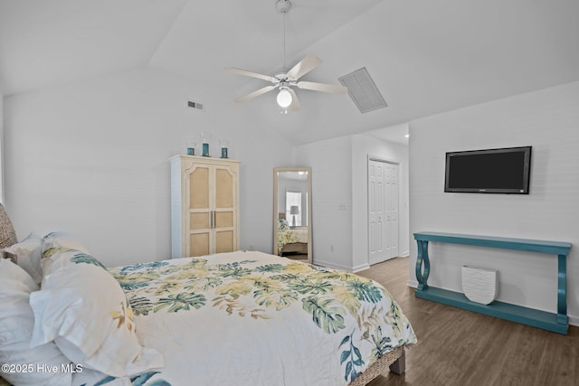 bedroom featuring lofted ceiling, a closet, visible vents, wood finished floors, and baseboards