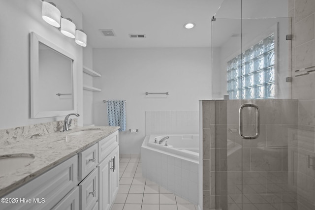 bathroom featuring double vanity, visible vents, tile patterned floors, a sink, and a bath