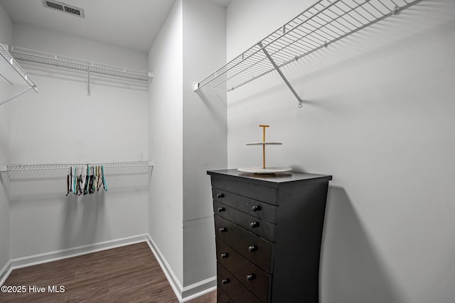 walk in closet featuring dark wood-type flooring and visible vents