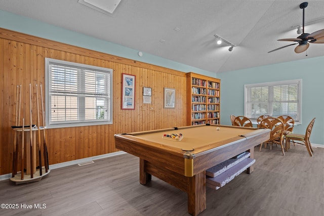 rec room with billiards, a textured ceiling, vaulted ceiling, and wood finished floors