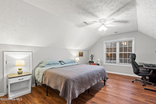 bedroom featuring a textured ceiling, wood finished floors, a ceiling fan, baseboards, and vaulted ceiling