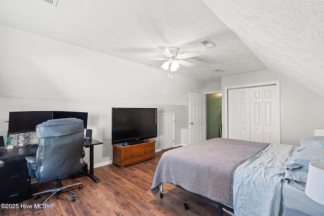 bedroom with a textured ceiling, a closet, wood finished floors, and visible vents