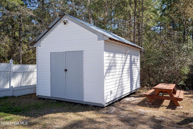 view of shed with fence