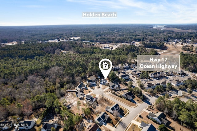 drone / aerial view featuring a wooded view