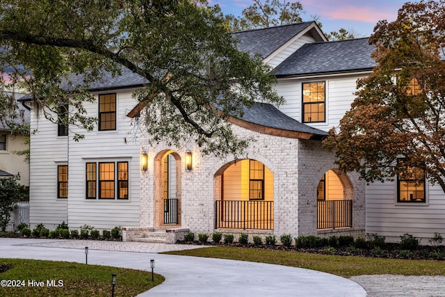 view of front of house with a shingled roof