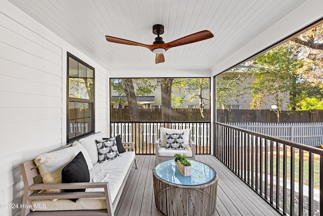 sunroom featuring wooden ceiling and a ceiling fan