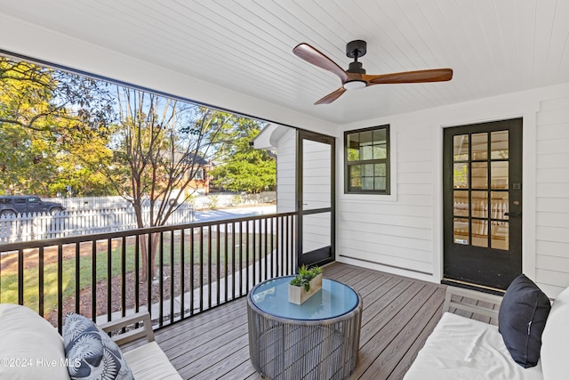 deck with ceiling fan and fence