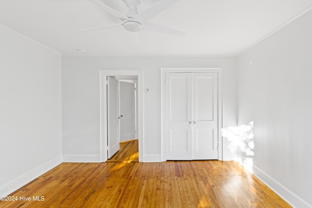 unfurnished bedroom with baseboards and hardwood / wood-style floors