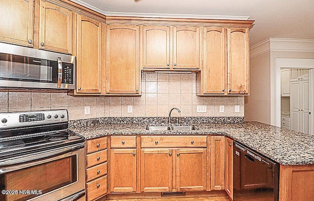 kitchen with backsplash, dark stone countertops, stainless steel appliances, and a sink