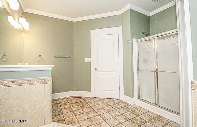 bathroom featuring a stall shower, baseboards, and ornamental molding