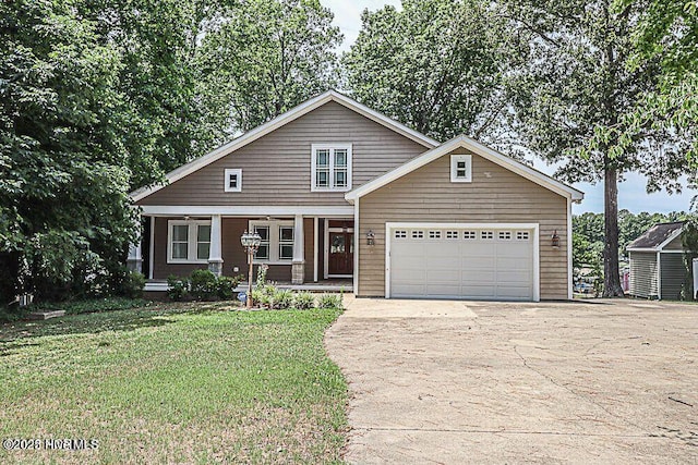 view of front of house with driveway, a ceiling fan, an attached garage, covered porch, and a front yard