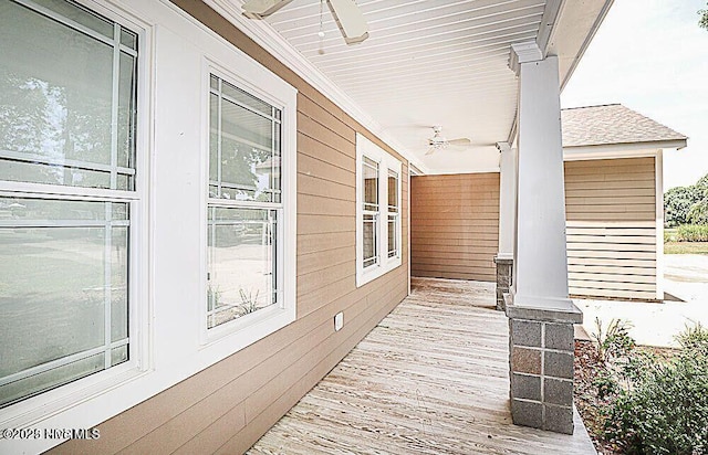 deck with a ceiling fan and covered porch